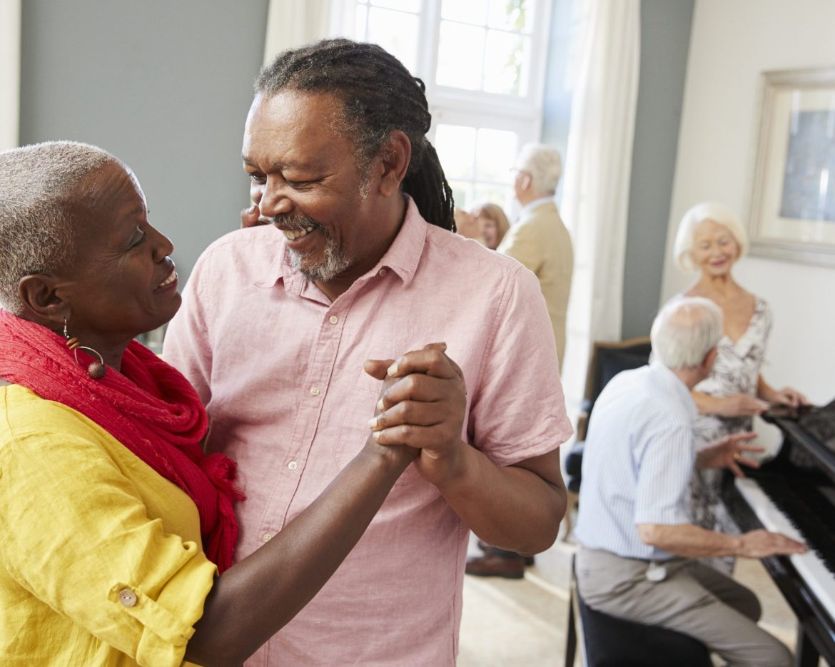 Group Of Seniors Enjoying Dancing Club Together