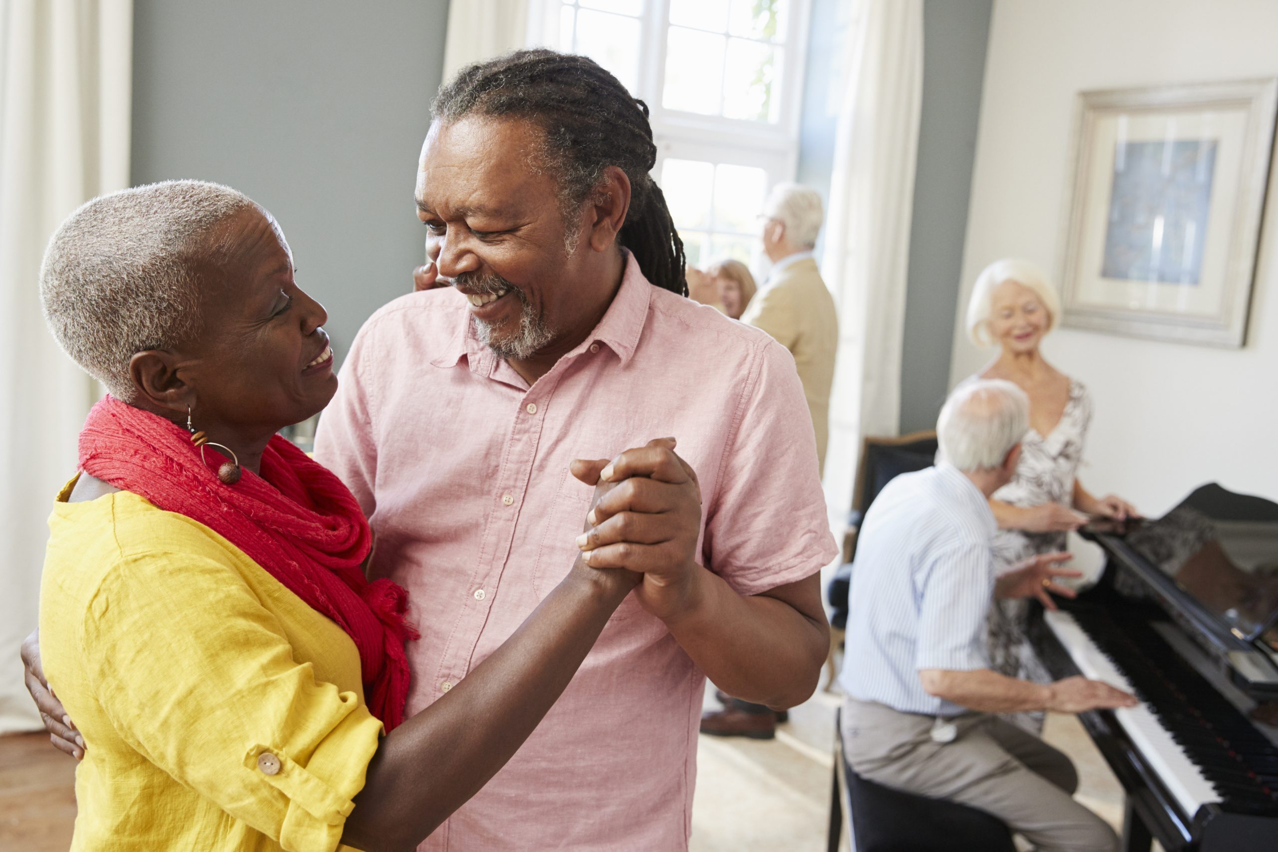Group Of Seniors Enjoying Dancing Club Together
